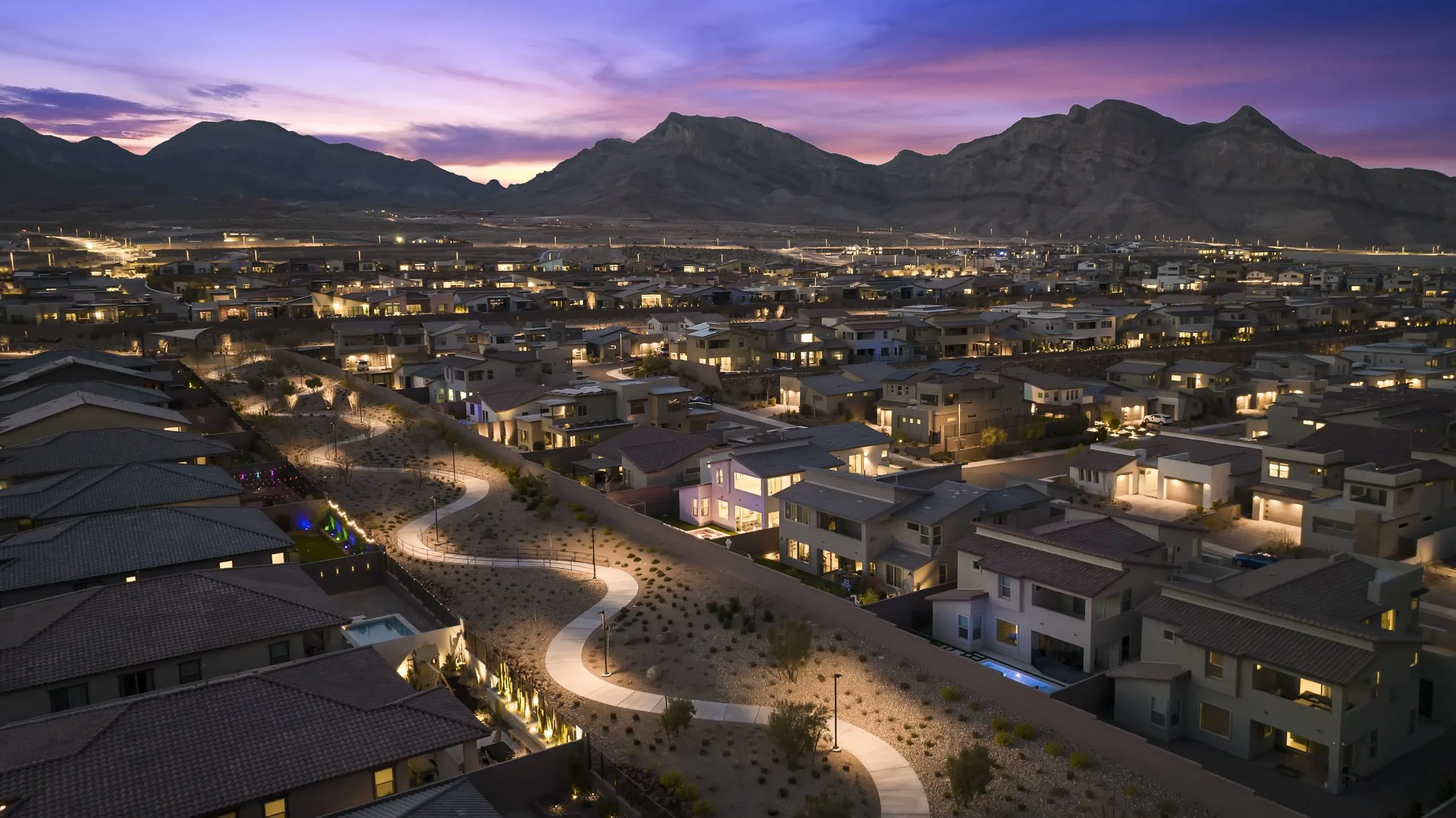 A Summerlin community at dusk with Red Rock Canyon beyond